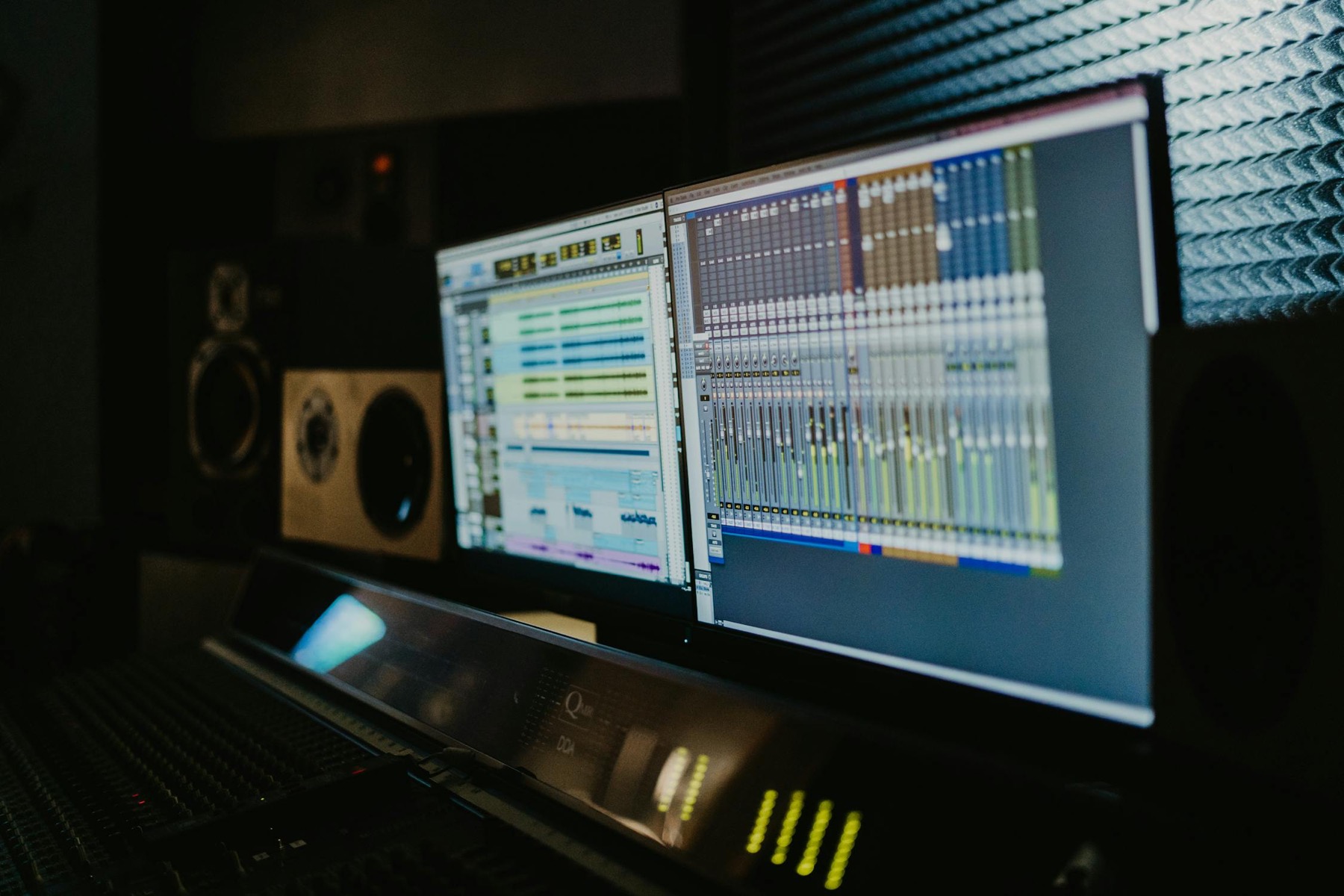 A multitrack recording session open on two studio screens